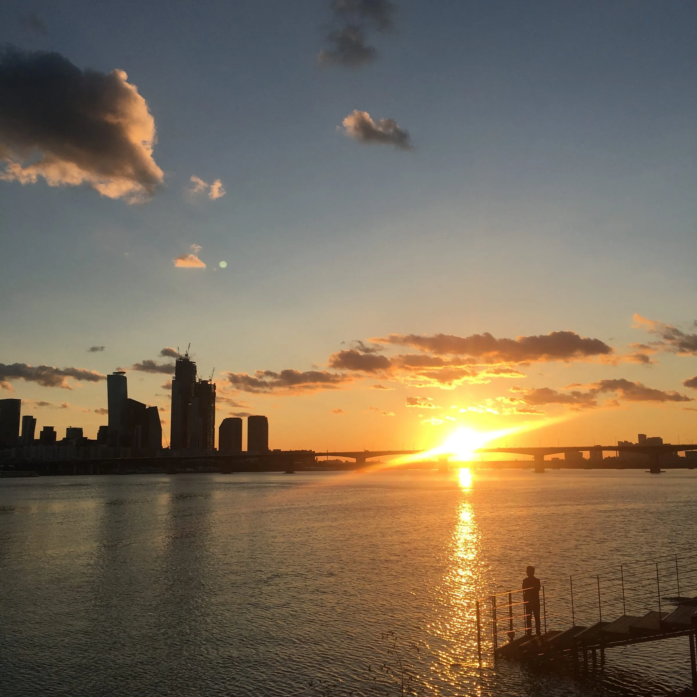 A vivid sunset blazing across the Han River at Ichon.