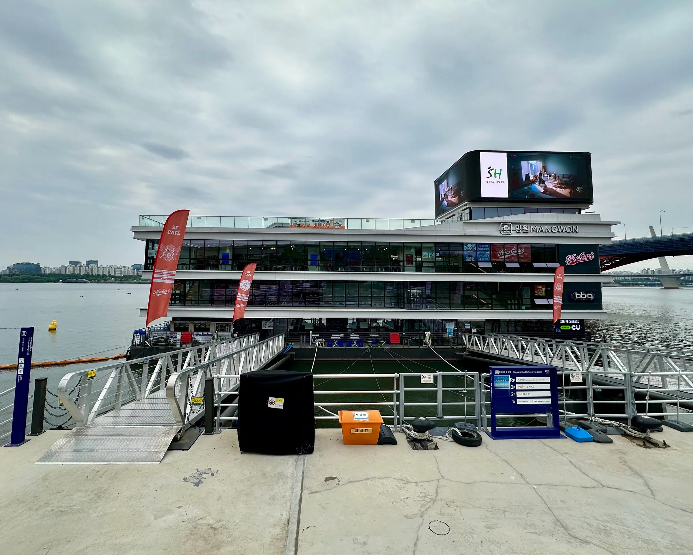 The Mangwon Hangang Bus floating terminal, multi-deck barge with restaurants and the MANGWON sign.