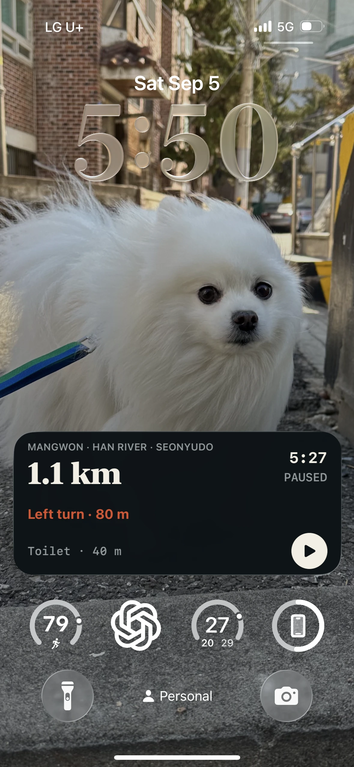 An iPhone lock screen during a run showing pace, distance and the next stop ahead