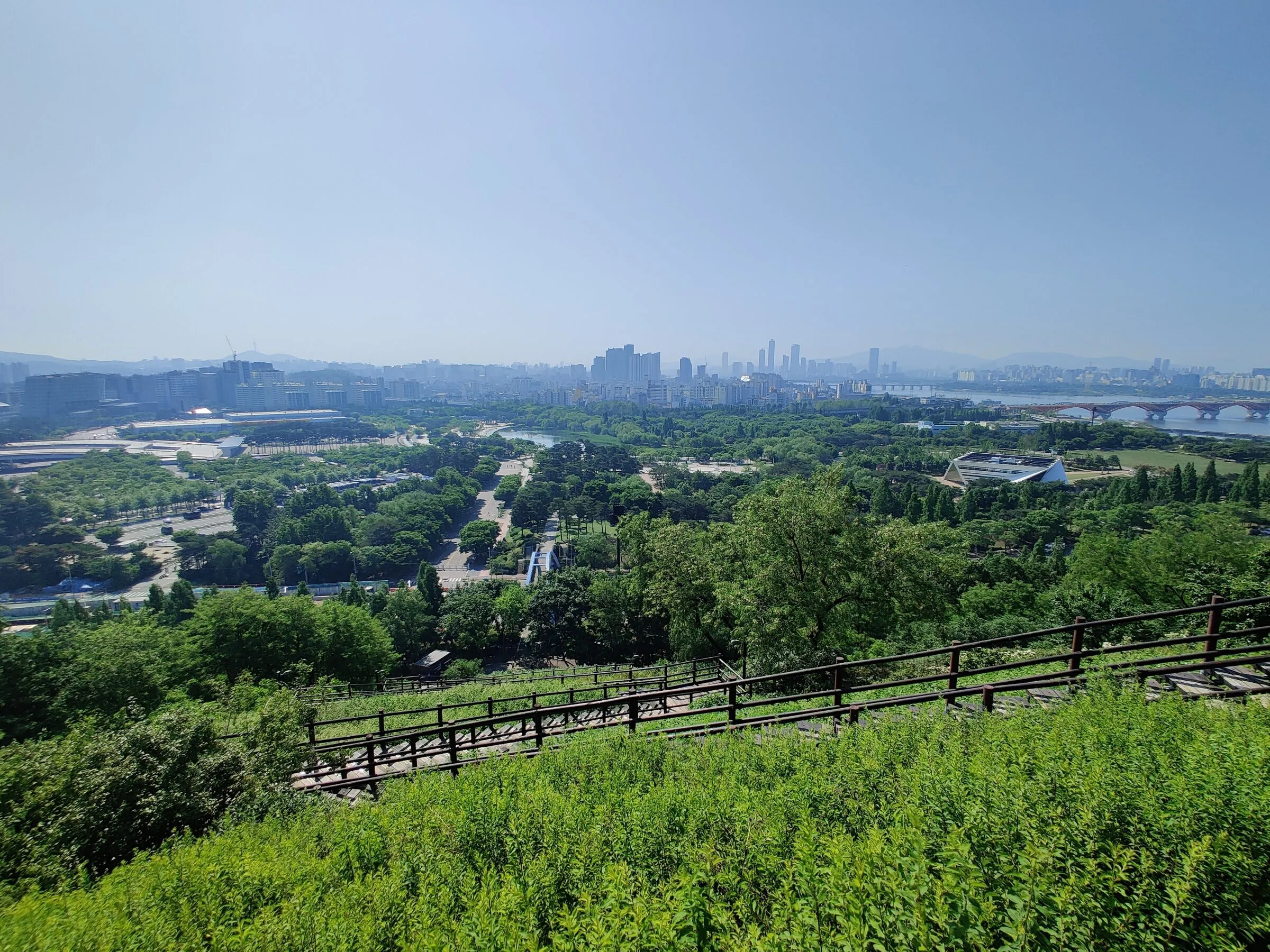 A fenced parkland trail at World Cup Park on a green spring morning.