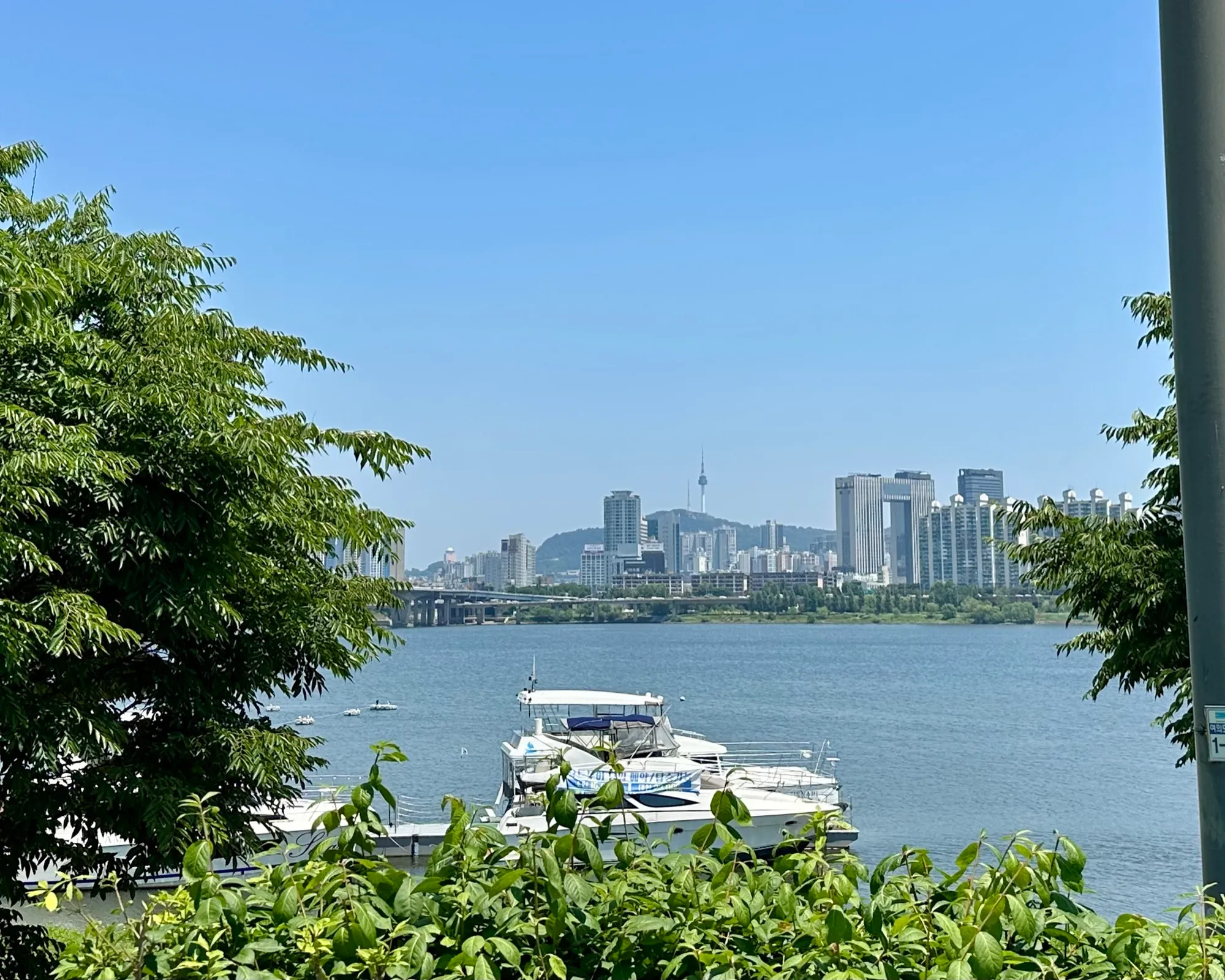 N Seoul Tower on Namsan seen in the distance from the Yeouido river path on a clear day.
